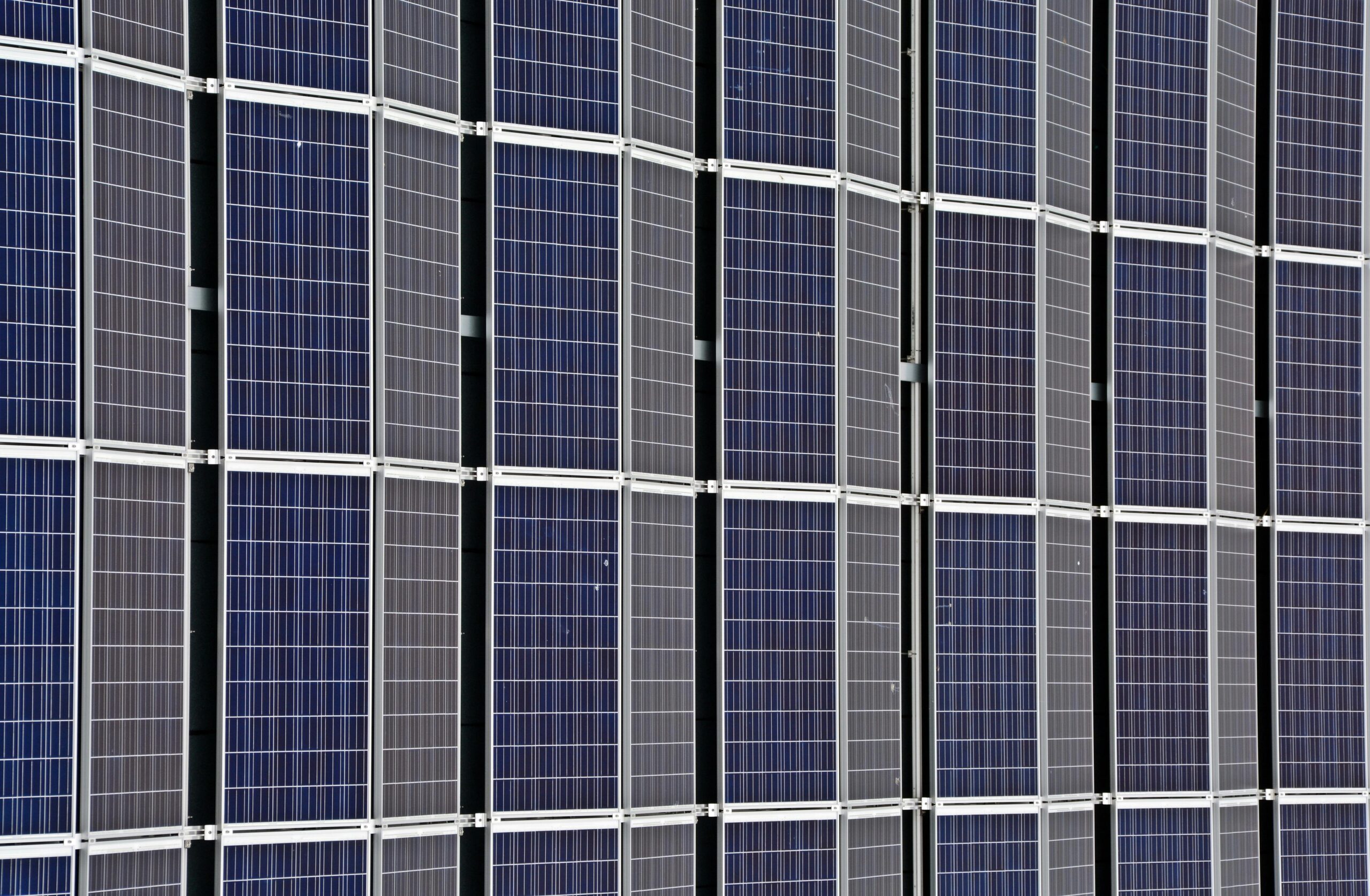 Close-up of multiple solar panels representing renewable energy and sustainability.